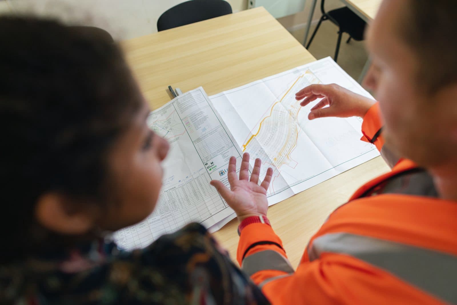Construction consultants reviewing plans with a client