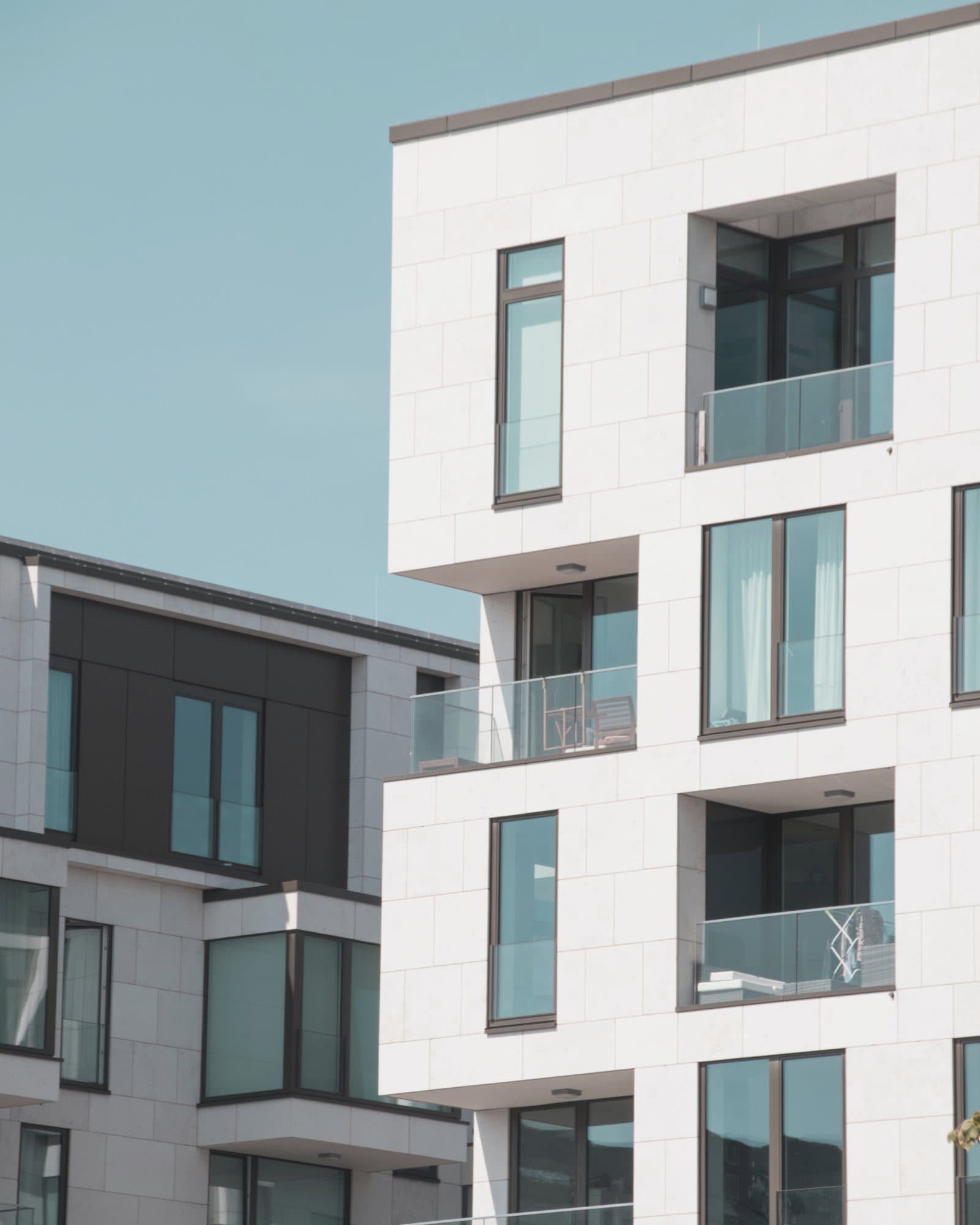 Modern apartment building with white façade and balconies