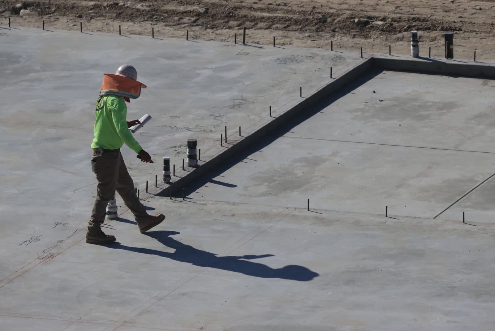 Engineer inspecting a concrete slab on site