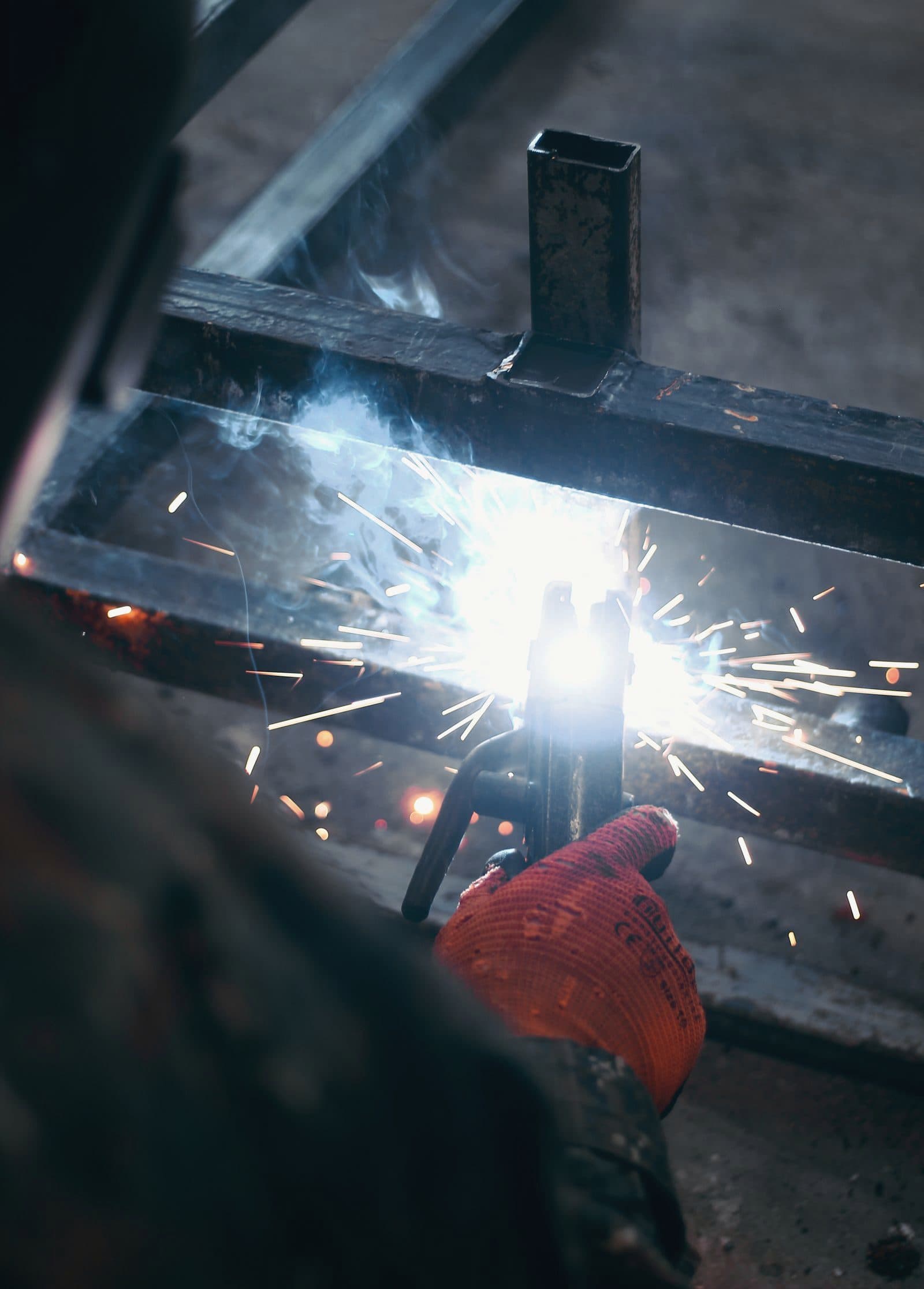 Welder joining steel with bright sparks